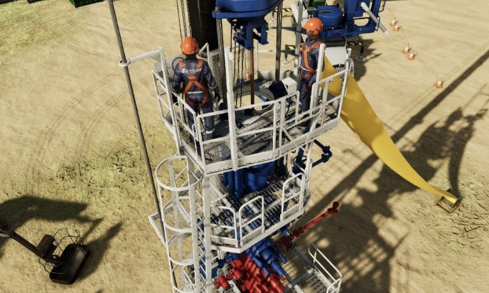 Two workers in safety gear are standing on a metal platform surrounded by industrial machinery at a construction or drilling site. Various equipment and supplies are visible in the background.